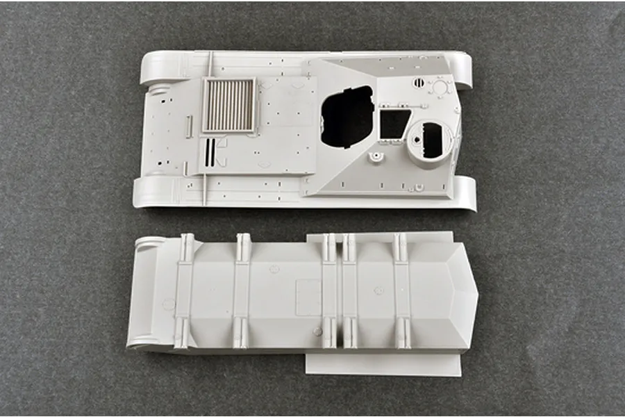 Top-down view of unpainted grey plastic model tank hull and upper deck parts for a 1/35 scale Soviet SU-101 model kit.
