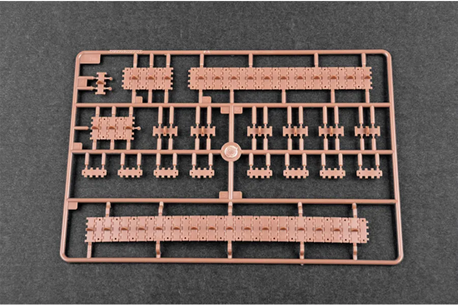A brown plastic sprue containing individual tank track links and track sections for a 1/35 scale model kit.
