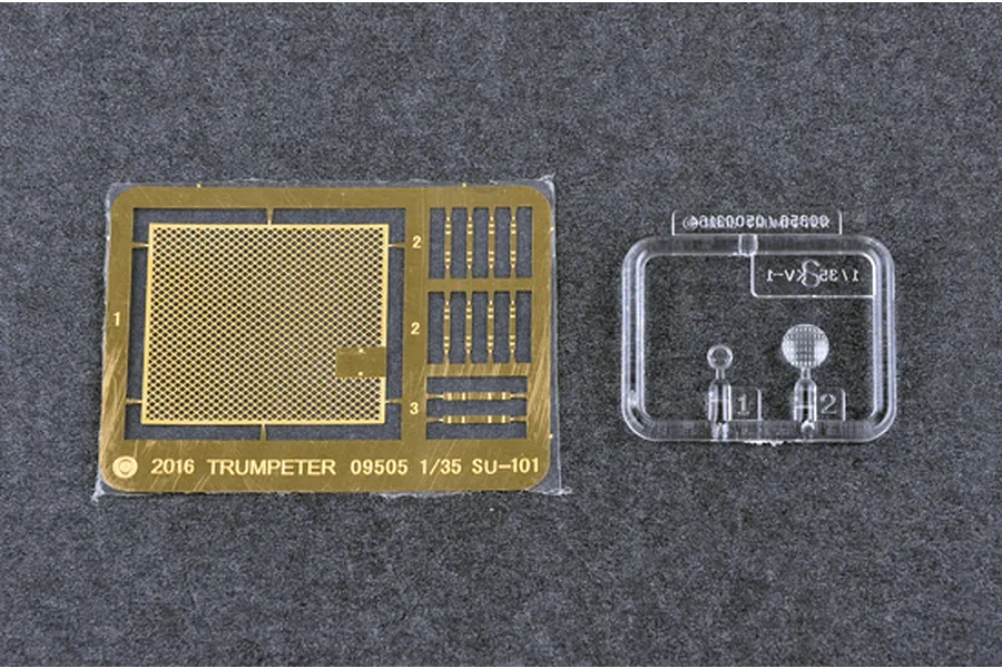 A photo-etched brass fret and a small clear plastic sprue for a 1/35 scale Trumpeter SU-101 model kit.