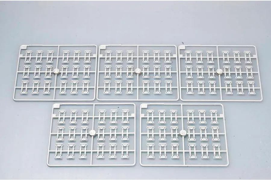 Five identical light grey plastic sprues containing individual tank track links for a 1/35 scale model kit.