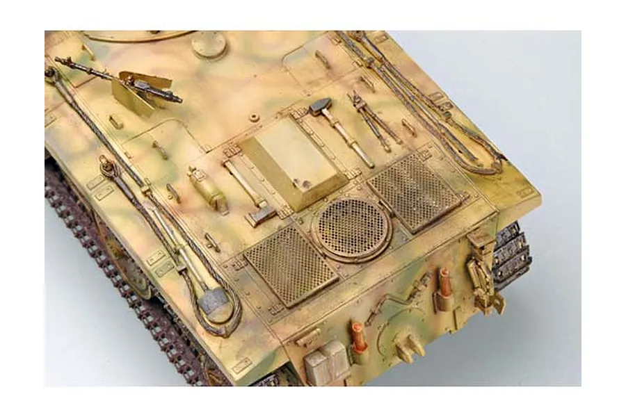 High-angle view of a 1/35 scale model of a German E10 tank, featuring detailed camouflage paint, engine deck grilles, and attached tools.