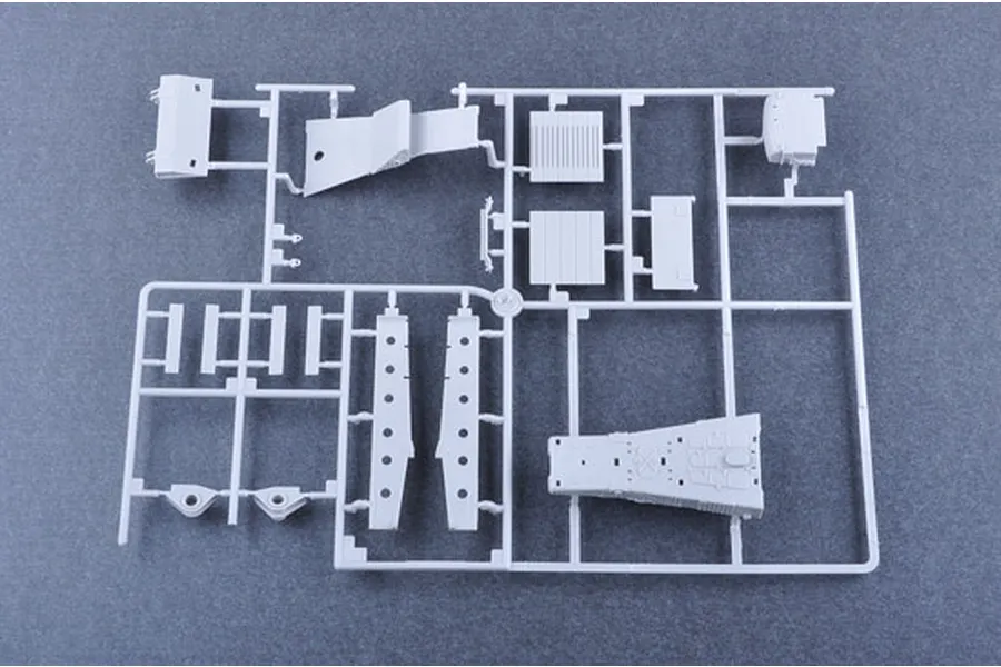 A grey plastic model kit sprue containing various unpainted parts for a 1/35 scale military vehicle model.