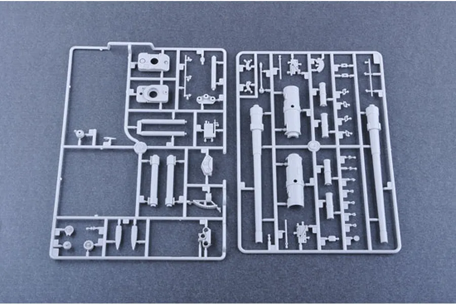Two grey plastic model kit sprues containing various parts for a 1/35 scale military vehicle model, laid out on a dark grey surface.