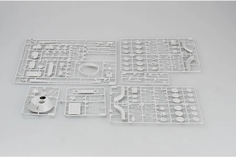 Five grey plastic model kit sprues for a 1/35 scale tank model laid out on a plain light grey background.