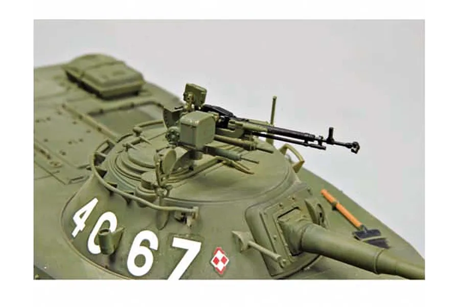 Close-up of a 1/35 scale model of a Polish PT-76B tank turret showing the machine gun, hatch, and markings.