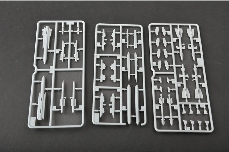Three grey plastic model kit sprues containing various missile and weapon parts for a 1/72 scale aircraft model.