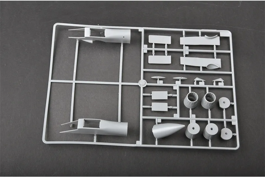 A grey plastic sprue containing model aircraft parts for a Trumpeter 1/72 scale Su-30MKK kit, including fuselage sections and engine nozzles.