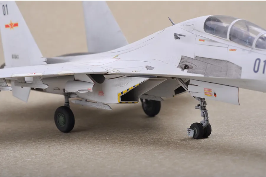 A close-up side view of a 1/72 scale plastic model of a Russian Su-30MKK Flanker G fighter jet, showing landing gear and cockpit details.