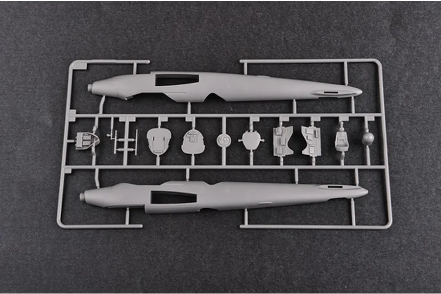 A grey plastic model aircraft sprue containing fuselage halves and cockpit components for a 1/48 scale model kit.