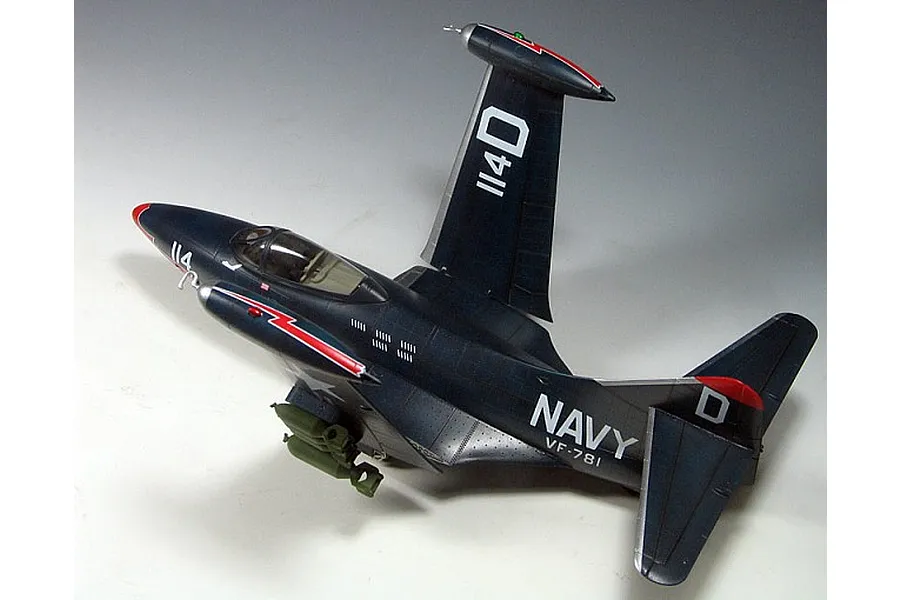A high-angle view of a finished 1/48 scale plastic model of a US Navy F9F-3 Panther fighter jet with wings folded.
