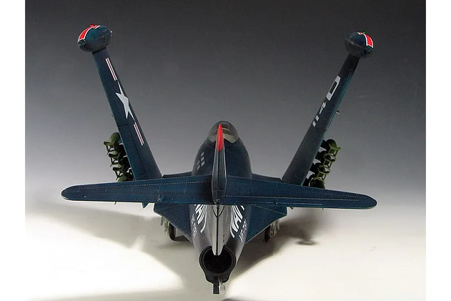 Rear view of a built and painted 1/48 scale Trumpeter F9F-3 Panther model jet with wings folded upwards.
