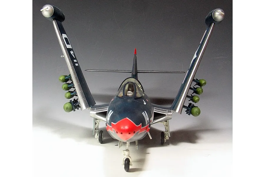 Front view of a 1/48 scale Trumpeter F9F-3 Panther model jet with wings folded up and green ordnance attached.