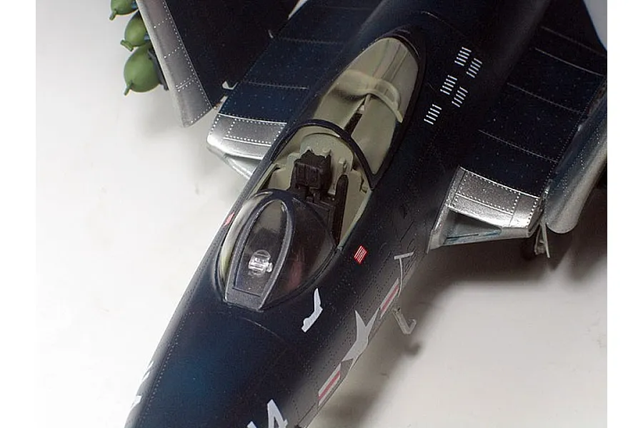 Top-down view of a 1/48 scale model F9F Panther jet, showing the cockpit, canopy, and folded wings against a plain white background.