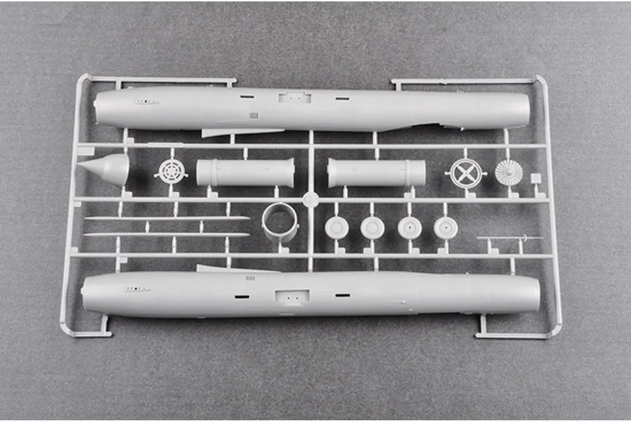 A grey plastic model kit sprue containing fuselage halves and various aircraft components for a 1/48 scale model aircraft.