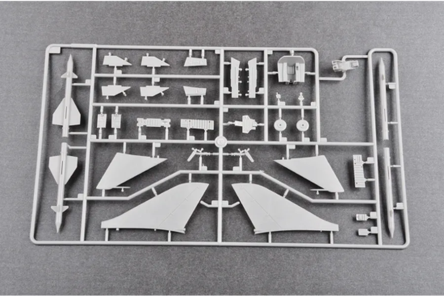 A grey plastic sprue containing various model aircraft parts including wings, missiles, and cockpit components for a 1/48 scale model kit.