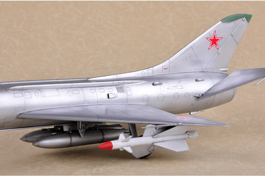 A close-up view of the rear fuselage and wing of a silver Su-11 Fishpot model aircraft, featuring a red star insignia on the tail fin.
