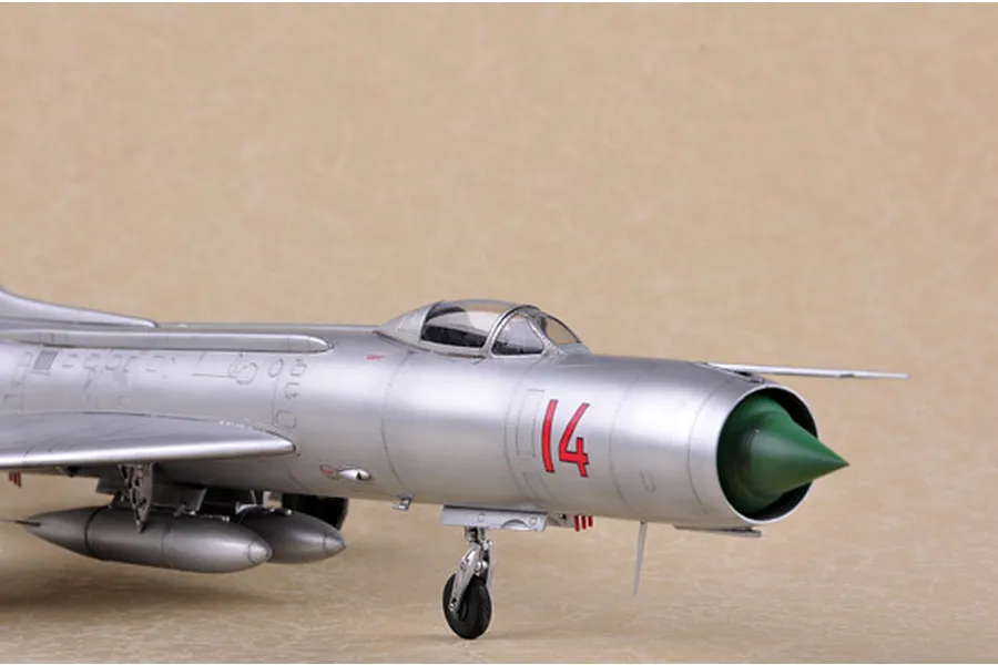 A close-up side view of a silver Soviet Su-11 Fishpot jet model aircraft with the number 14 in red on the fuselage.