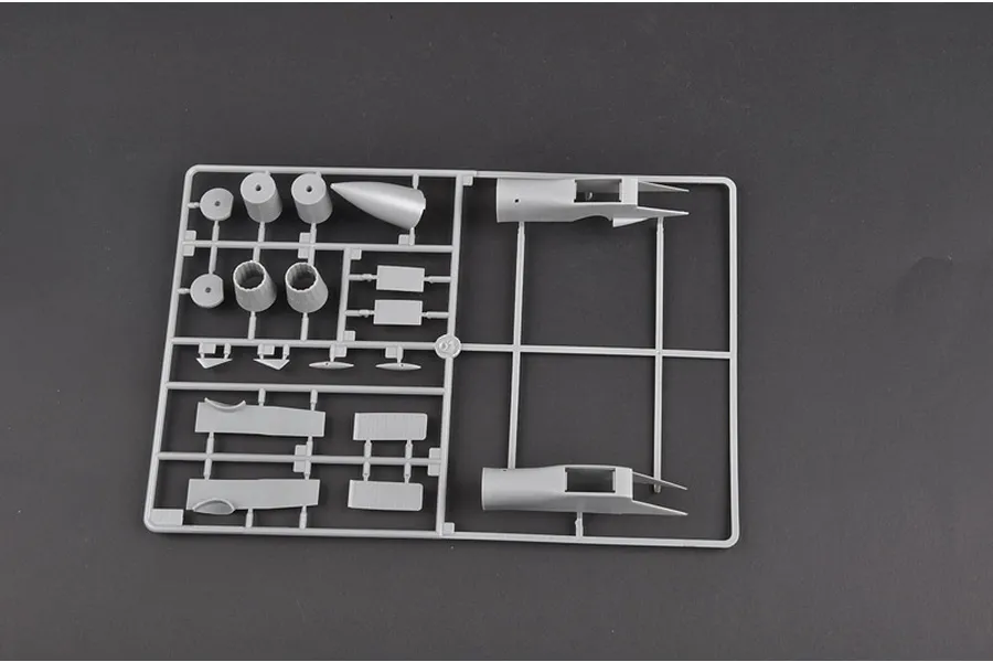 A grey plastic sprue containing various model aircraft parts for a 1/72 scale Su-27 fighter jet kit.