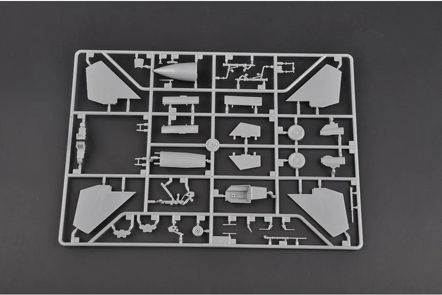 A grey plastic sprue containing various model aircraft parts for a 1/72 scale Su-27 fighter jet model kit.