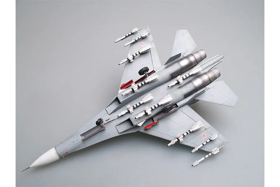 A fully assembled and painted 1/72 scale model of a Russian Su-27UB fighter jet, viewed from the underside against a plain grey background.