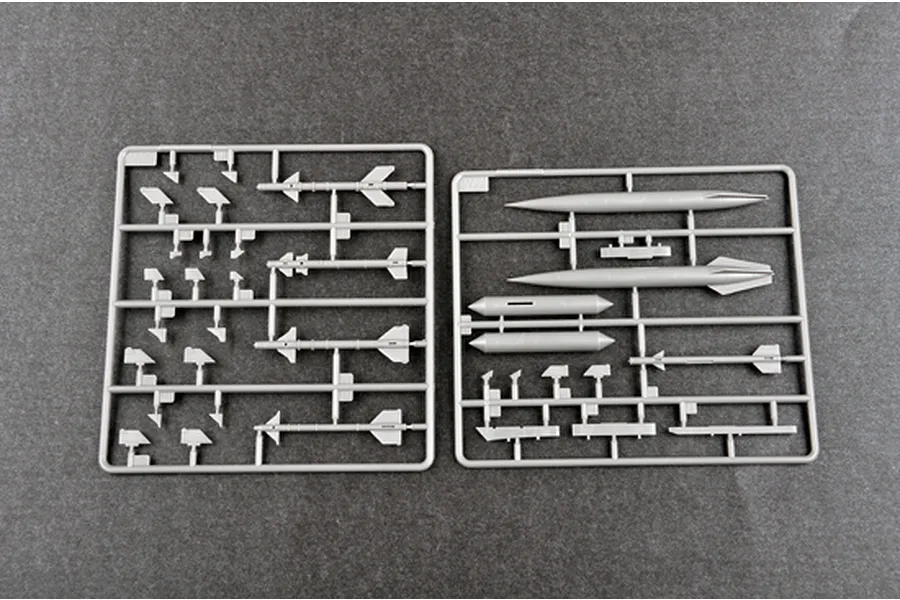 Two grey plastic model kit sprues containing various missile and fuel tank components for a 1/48 scale aircraft model.