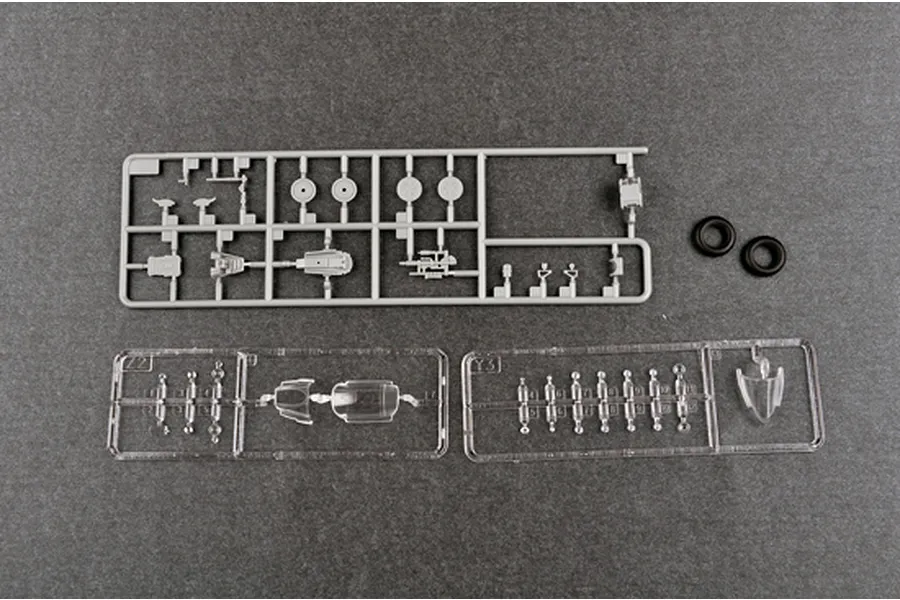 Plastic model kit sprues for a Trumpeter 1/48 scale aircraft model, including grey plastic parts, clear canopy parts, and two black rubber tires.