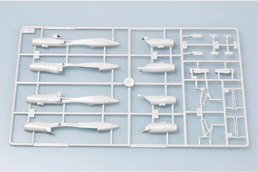 A grey plastic model kit sprue containing various aircraft fuselage and landing gear parts for a 1/144 scale model.