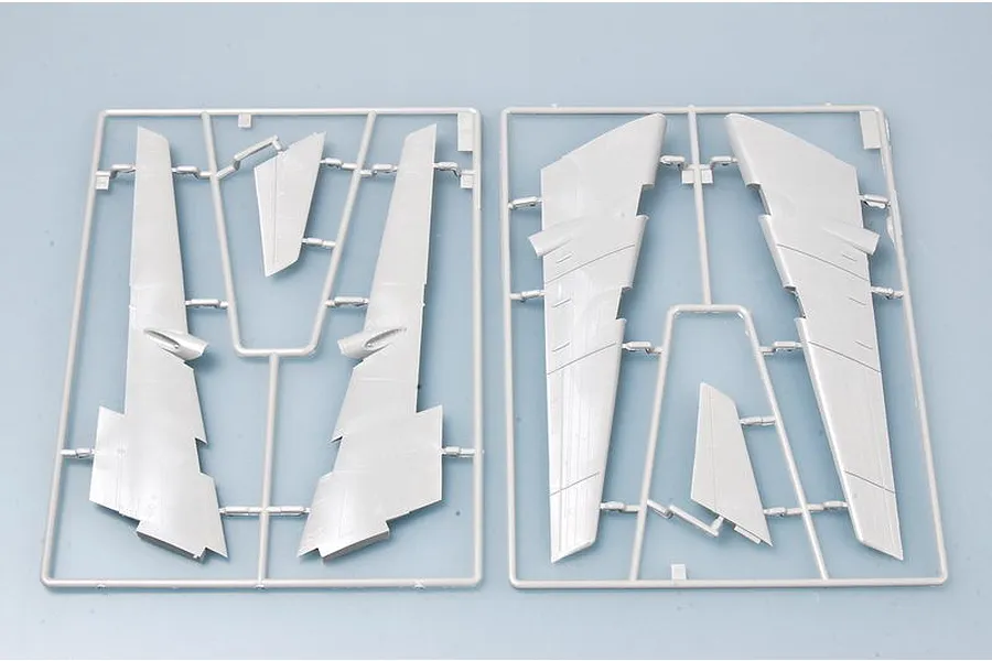 Two grey plastic model kit sprues containing aircraft wing and tail components for a 1/144 scale model.