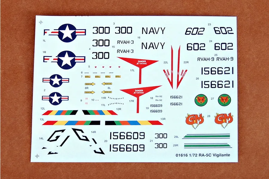 A decal sheet for a 1/72 scale Trumpeter RA-5C Vigilante model kit, featuring various military aircraft markings, numbers, and insignia on a white backing.