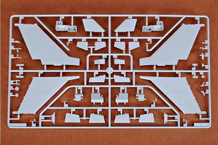 A grey plastic sprue from a Trumpeter 1/72 scale model kit containing various aircraft wing and tail components.
