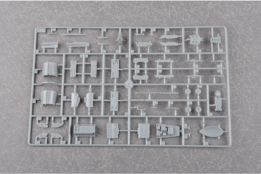 A grey plastic sprue from a Trumpeter 1/48 scale J-7G model kit featuring various aircraft parts attached to a frame.
