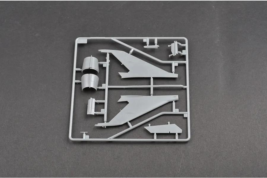 A grey plastic sprue from a Trumpeter 1/48 scale MiG-21F-13 model kit, featuring aircraft wing and fuselage components.