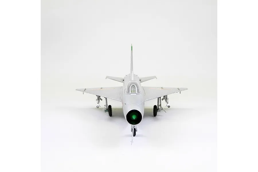 Front view of a 1/48 scale Trumpeter MiG-21F-13 Fishbed model aircraft, featuring a silver finish and landing gear, set against a plain white background.