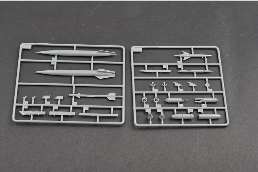 Two grey plastic model kit sprues containing various missile and weapon parts for a 1/48 scale aircraft model.
