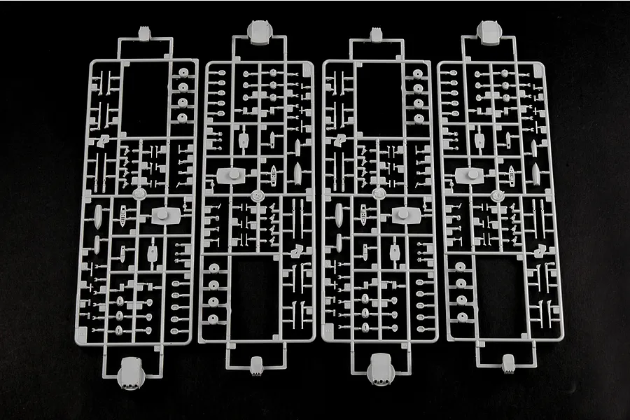 Four identical grey plastic model kit sprues containing various small ship parts, arranged side by side on a black background.