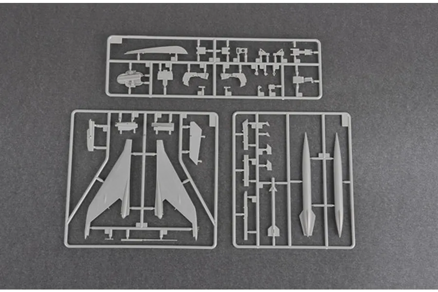 Three grey plastic model kit sprues containing aircraft parts for a Trumpeter 1/48 J-7B fighter jet model.