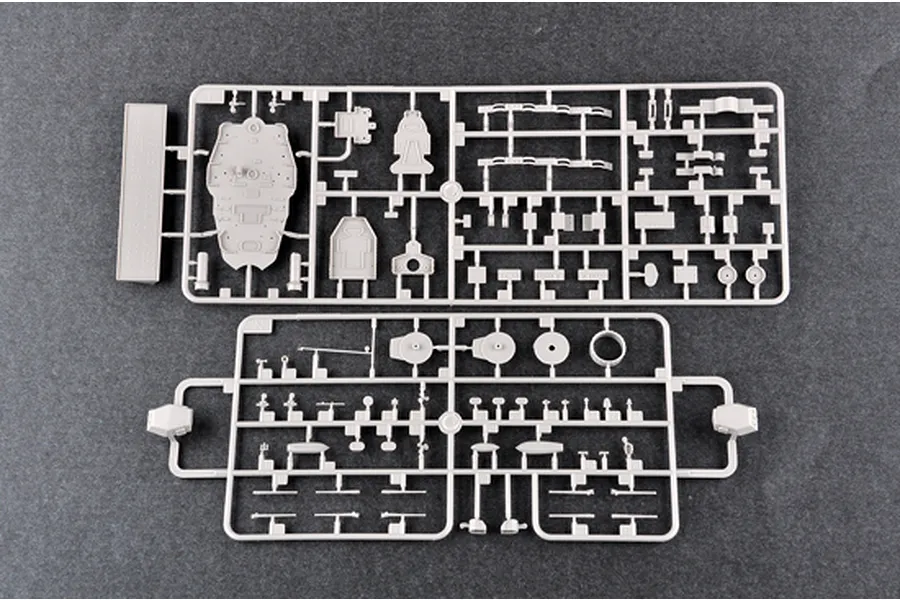 Two grey plastic model kit sprues containing various ship parts laid out on a dark surface.