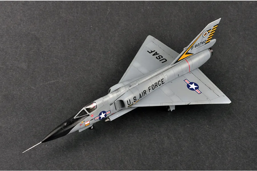A high-angle studio shot of a fully assembled and painted 1/72 scale F-106A Delta Dart model aircraft on a dark grey surface.