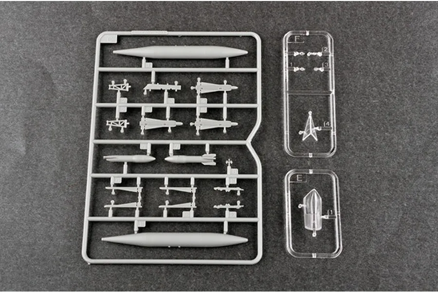 Plastic model kit sprues for a 1/72 scale F-106A Delta Dart, including grey weapon parts and clear canopy parts on a dark background.