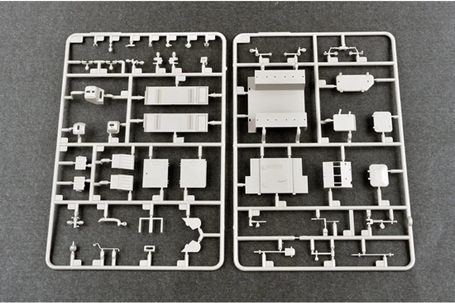 Two grey plastic model kit sprues containing various vehicle parts for the Trumpeter 1/35 Soviet AT-P Artillery Tractor model kit.