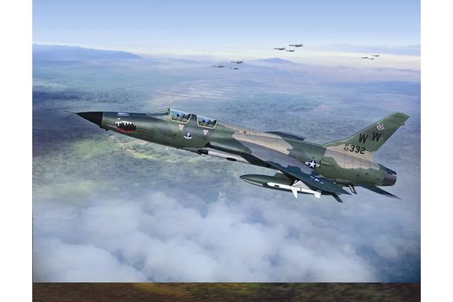 An artistic illustration of a US Air Force F-105G Wild Weasel jet flying over a landscape with other aircraft in the distance.
