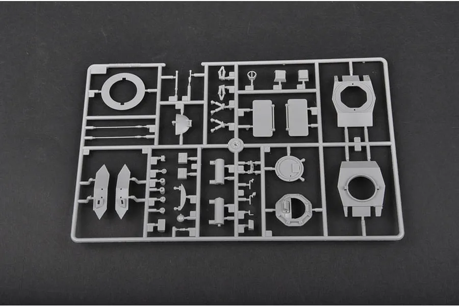 A grey plastic sprue containing various parts for a 1/35 scale model kit, including turret components and hatches.