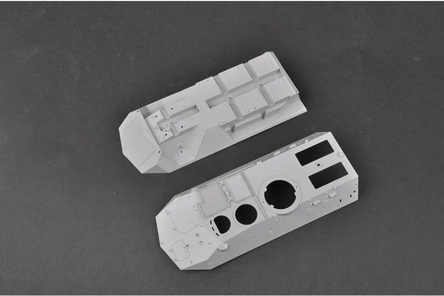 Two unpainted grey plastic model kit parts for the Trumpeter 1/35 Canadian Grizzly AVGP, showing the upper and lower hull sections.