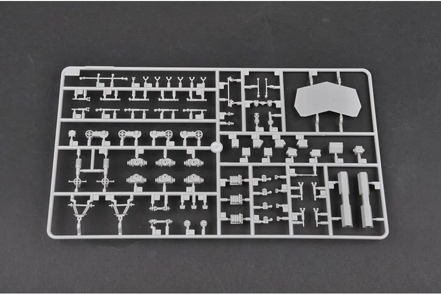 A grey plastic sprue containing various small model parts for a 1/35 scale military vehicle kit, set against a dark grey background.