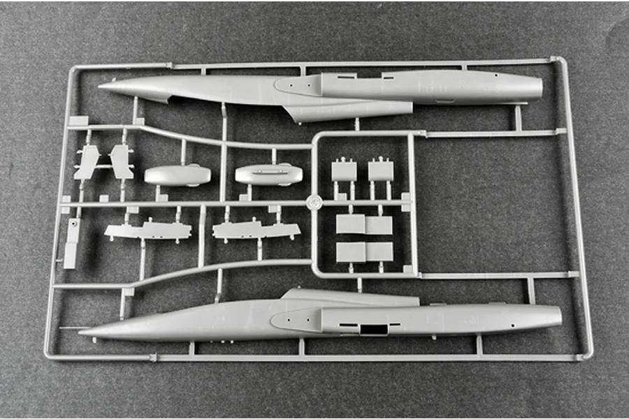 A grey plastic model kit sprue containing fuselage halves and various aircraft components for a 1/48 scale model.