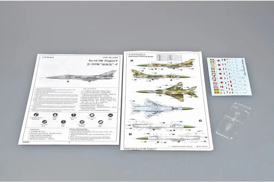 Instruction manuals, decal sheet, and a small clear plastic part for the Trumpeter 1/72 Su-15TM Flagon-F model kit.