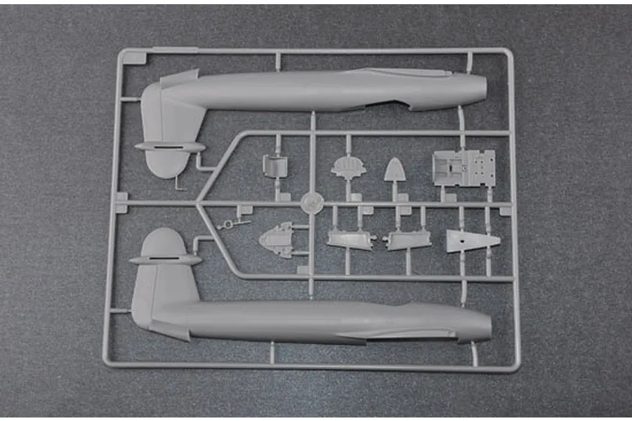 A grey plastic sprue containing fuselage halves and cockpit components for a 1/48 scale model aircraft kit.