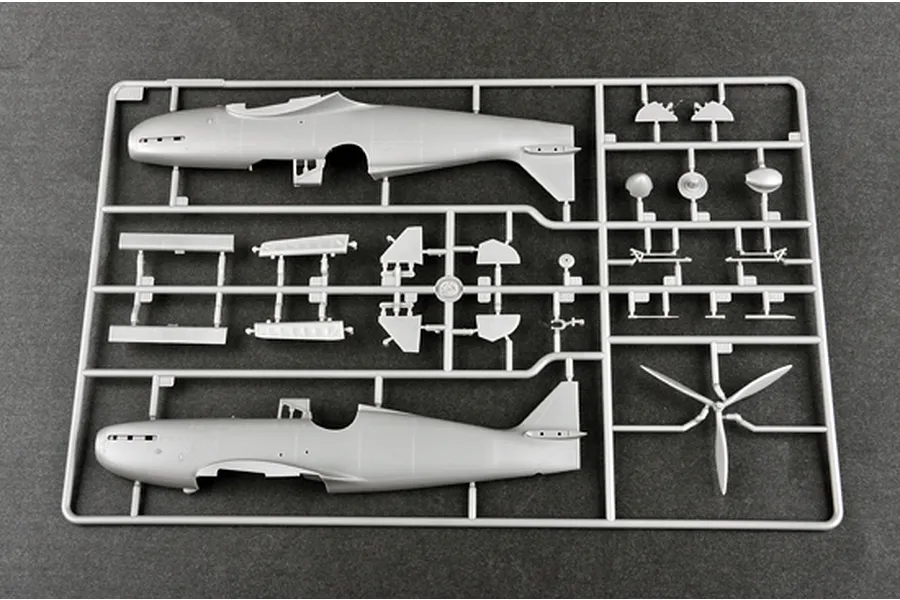 A grey plastic sprue from a Trumpeter 1/48 scale model kit showing aircraft fuselage halves and propeller parts.
