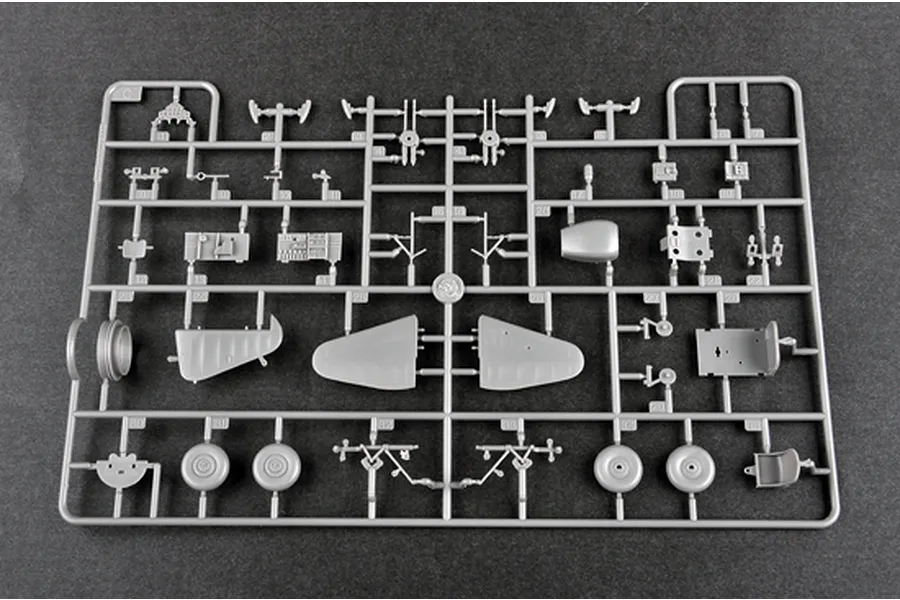 A grey plastic sprue containing various model aircraft parts for a 1/48 scale Boulton Paul Defiant model kit, including wings, wheels, and cockpit details.