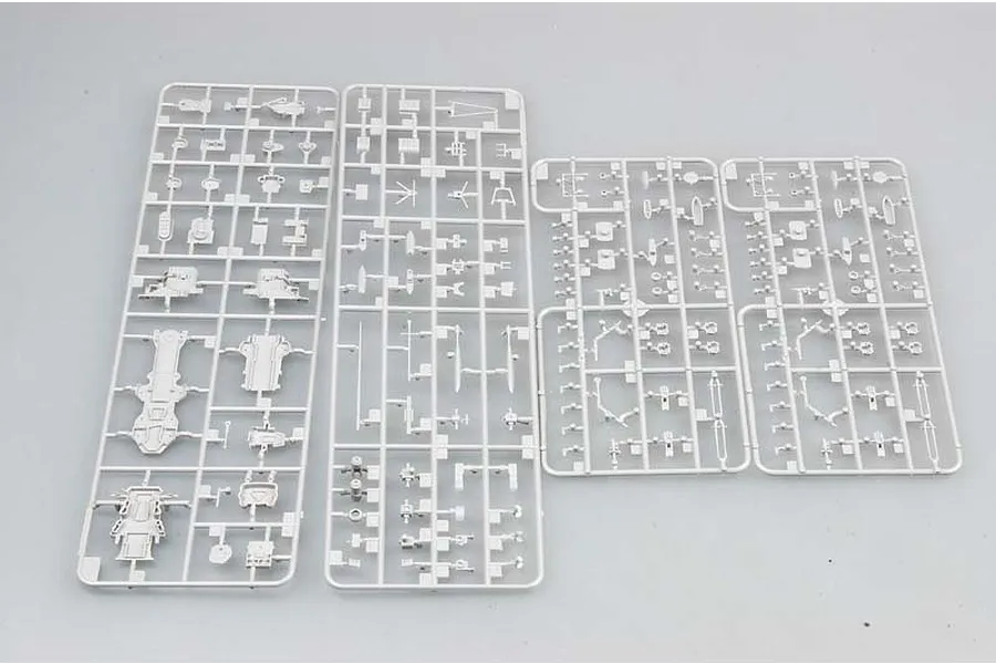 Four grey plastic model kit sprues containing various ship parts laid out on a plain background.